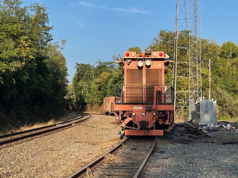 Orange colored railway maintenance of way equipment