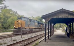 A CSX freight train passes a covered station platform in Duffields, West Virginia