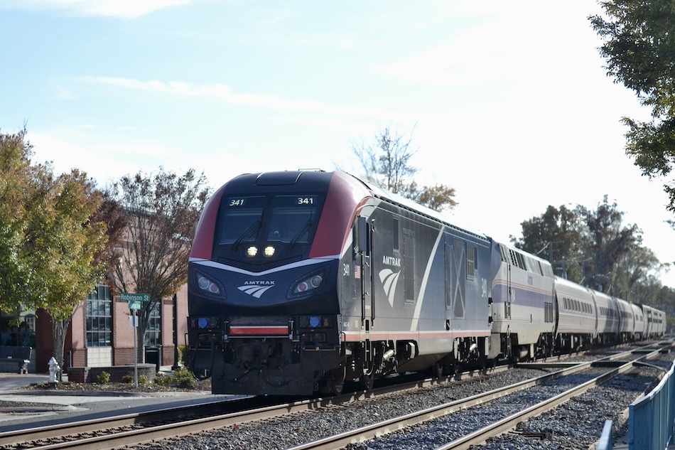 An Amtrak passenger train runs through Ashland, Virginia