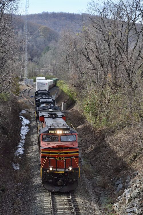 The colorful red Norfolk Southern 8114 leads an intermodal train past the siding at Linden, Virginia