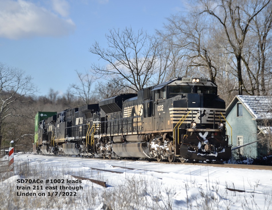 A Norfolk Southern train passes through the snow