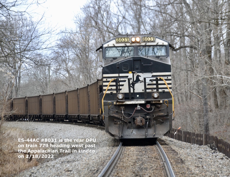 Looking straight at the rear of a Norfolk Southern empty hopper train with a rear DPU facing nose out