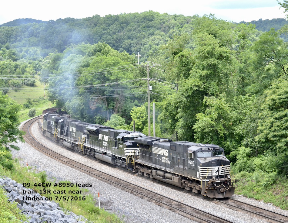 Four Norfolk Southern locomotives lead a freight train around a curve